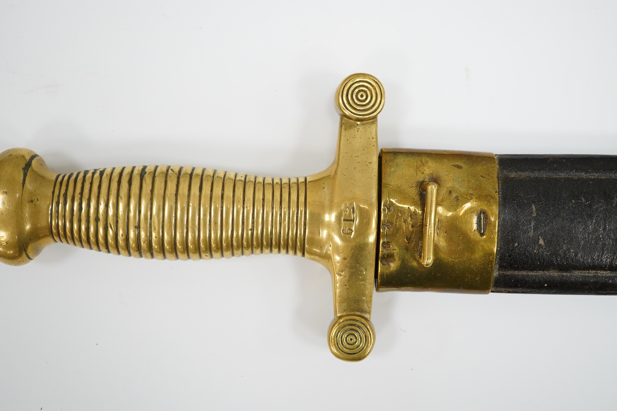 A 19th century French infantryman’s sidearm Gladius with swollen double edged blade, and regulation cast brass cruciform hilt, in its brass mounted leather scabbard, together with a continental bayonet also in scabbard.